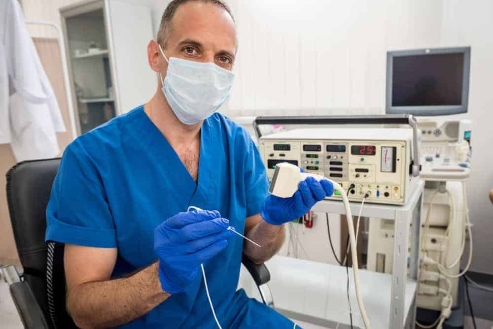 A pain management specialist in NYC consulting with a patient about sciatica symptoms and treatment options, focusing on nerve pain relief and restoring mobility.