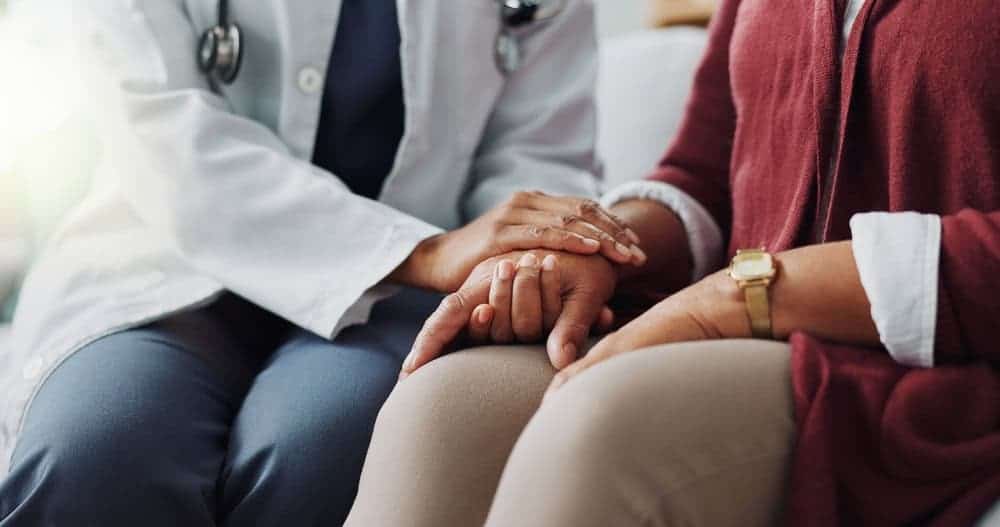 Close-up of an expert physiotherapist’s hand gently supporting a patient’s hand, symbolizing trust, care, and professional pain relief services at NY Spine Medicine in NYC.